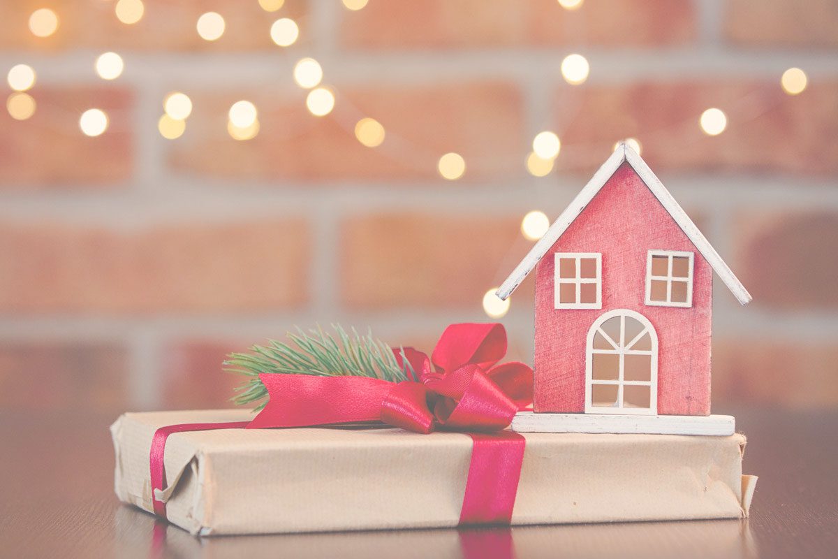Model house and a gift tied in ribbon image for are there tax implications for making gifts blog