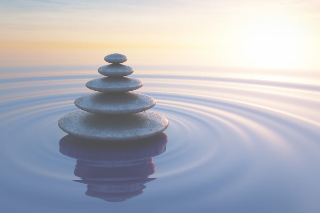 Neat pile of stones in calm water image for assisted dying bill explained blog