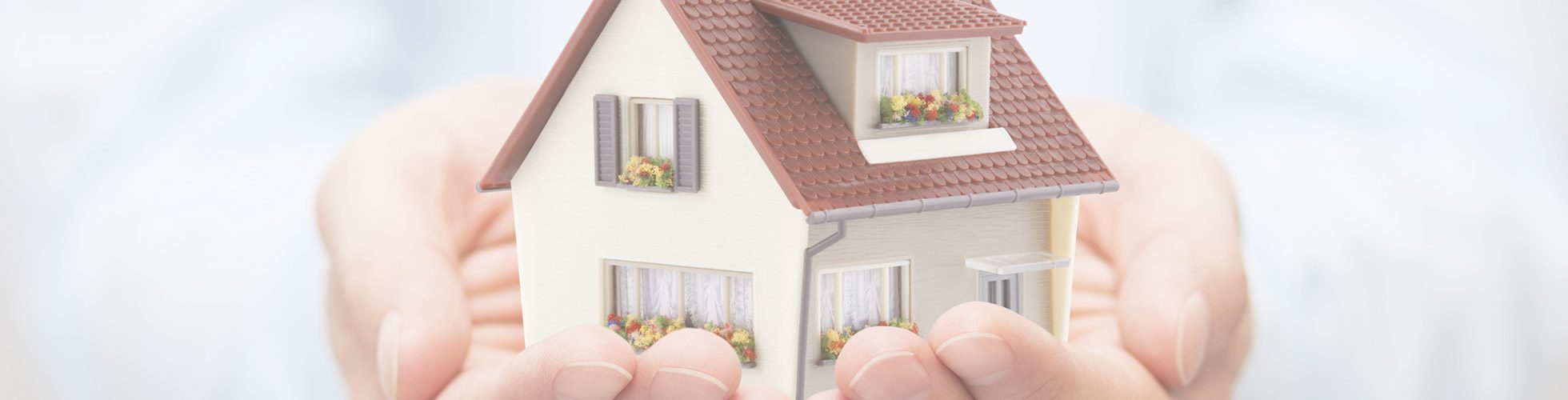 Image of hands holding a toy house for Will the ‘feudal’ leasehold system finally be overhauled? blog